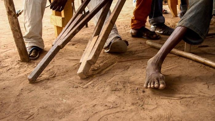 A photo showing crutches and laid besides a person with disabilities.