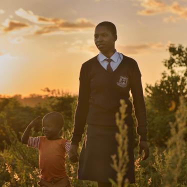 “Angela,” 20, walks with her son near her home after returning from school in Migori county, western Kenya