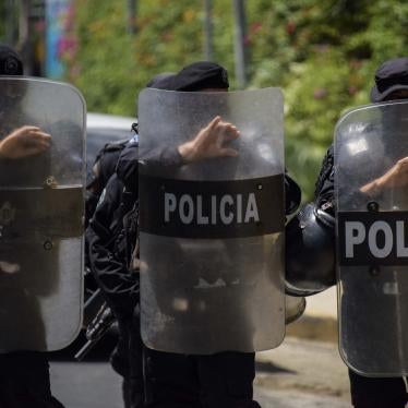 A row of police holding riot shields