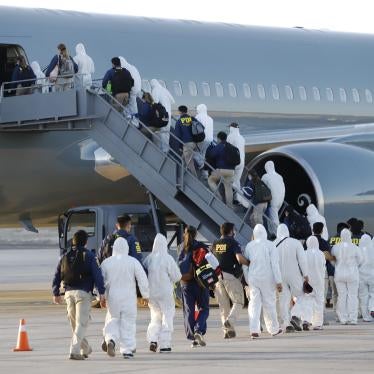 Venezuelan migrants board a plane as they are being deported from Chile, at the General Diego Aracena Aguilar International Airport in Iquique, Chile, on February 10, 2021. 