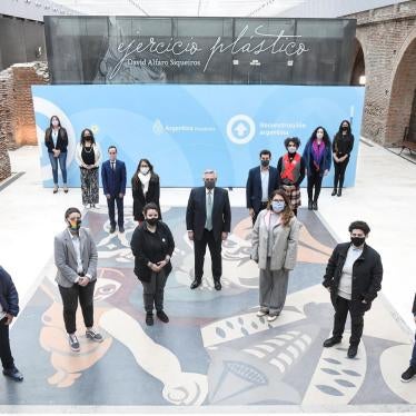 President Alberto Fernández (center) with other authorities and members of social organizations, form an 'X', at the Bicentennial Museum in Casa Rosada, Buenos Aires, Argentina, on July 21, 2021