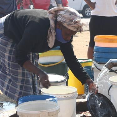 A woman collects water at a borehole in Mabvuku, Harare in Zimbabwe, August 28, 2021.