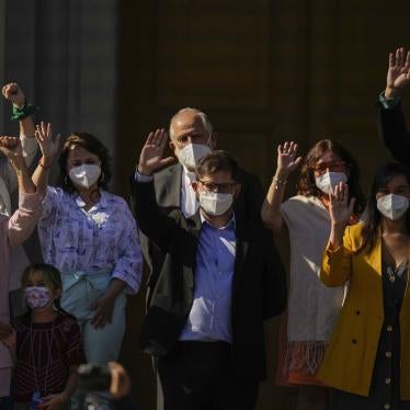 People waving with face masks on 