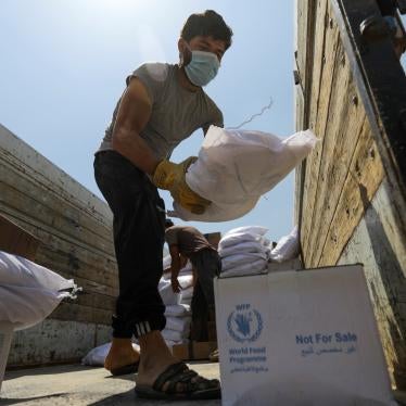 A worker unloads bags and boxes of humanitarian aid from the back of a truck in the opposition-held Idlib, Syria, June 9, 2021.