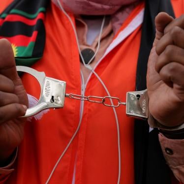 Activists in prison jumpsuits and handcuffs protest human rights abuses against the Oromo people in Ethiopia at a demonstration in London, October 10, 2020. © 2020 David Cliff/NurPhoto via AP