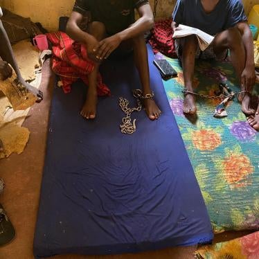 Four men sit chained in a room at the Coptic Church Mamboleo, in Kisumu city, western Kenya, where over 60 men, women, and children with real or perceived mental health conditions are detained. Staff at the church say residents are naked or partially clothed so that they do not run away or escape. 