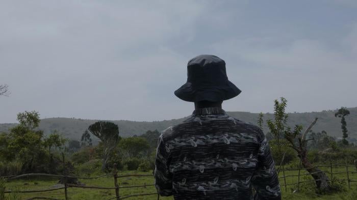 A farmer looks out at the Ugandan landscape.