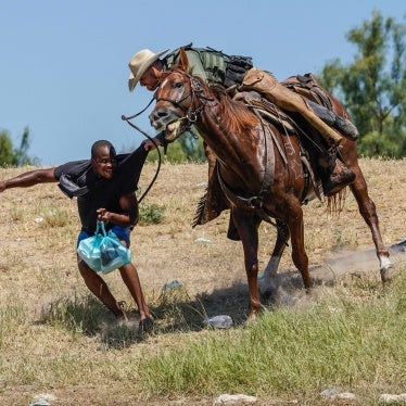 United States Border Patrol agent on horseback tries to stop Haitian migrants from entering an encampment on the banks of the Rio Grande near the Acuña Del Rio International Bridge in Del Rio, Texas on September 19, 2021.