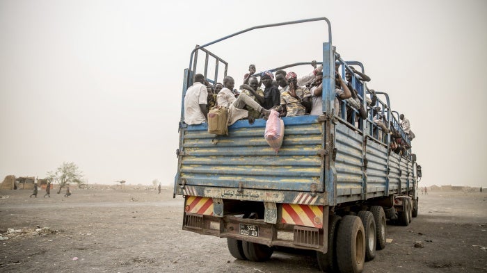 Refugees are taken in trucks