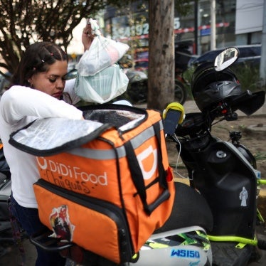 A delivery driver for Didi Food, getting ready to deliver orders, in Mexico City, Mexico, on October 16, 2024, could be one of many workers to benefit from labor reform for workers for digital labor platforms.