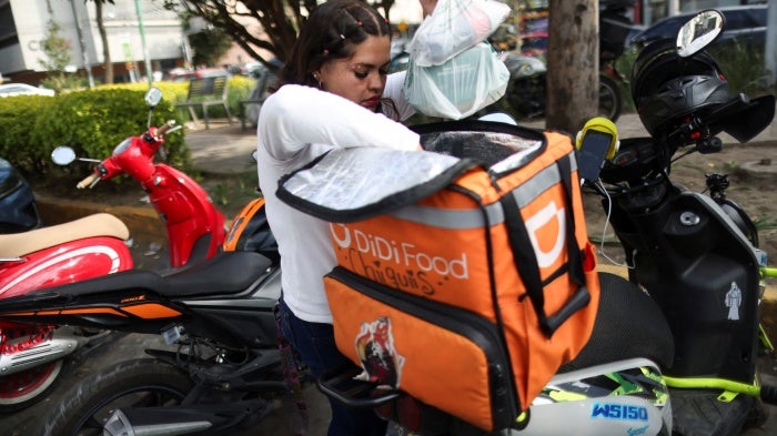 A delivery driver for Didi Food, getting ready to deliver orders, in Mexico City, Mexico, on October 16, 2024, could be one of many workers to benefit from labor reform for workers for digital labor platforms.