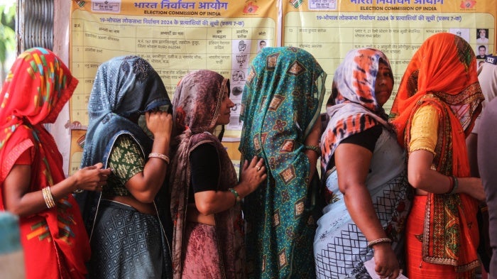 Voters wait at a polling station