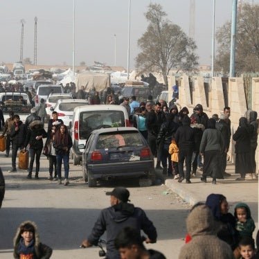 Displaced people who fled the Aleppo countryside walk in Tabqa, Syria, December 4, 2024. 