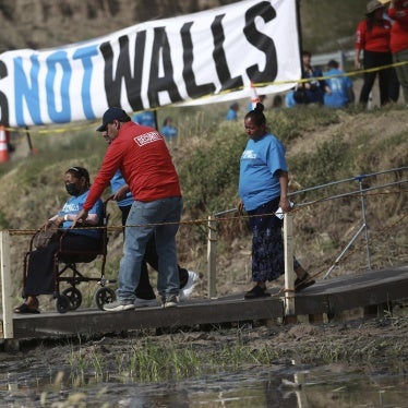 People living in Mexico cross a temporary bridge to meet with relatives living in the U.S., during the 10th annual "Hugs not Walls" event on a stretch of the Rio Grande, in Ciudad Juarez, Mexico, Saturday, May 6, 2023. The brief family reunions are part of a campaign sponsored by the Border Network for Human Rights, an immigration rights group. © 2023 AP Photo/Christian Chavez