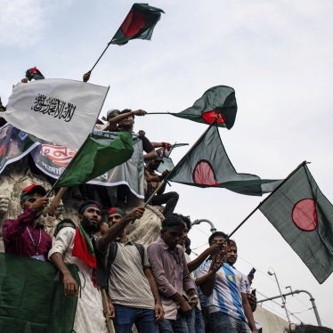 A group of people waving flags at a protest