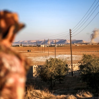 A fighter of the Turkish-backed Syrian National Army faction looks towards a bombardment near the Tishrin Dam in the vicinity of Manbij, in the east of Syria's northern Aleppo province, on January 10, 2025.