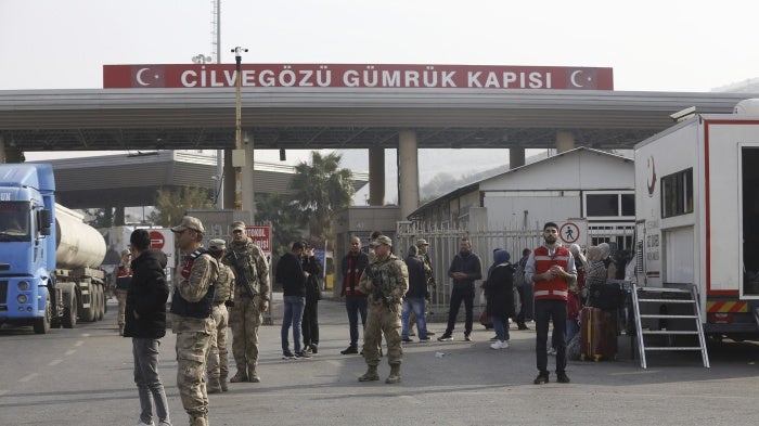 Syrian refugees in Turkey gather at Cilvegozu border gate on Turkish-Syrian border, after the fall of Assad regime in Syria, at Reyhanli district in Hatay, Turkey, December 10, 2024.