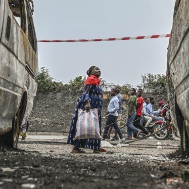 Residents walk by charred vehicles in Goma, Democratic Republic of Congo, January 31, 2025.