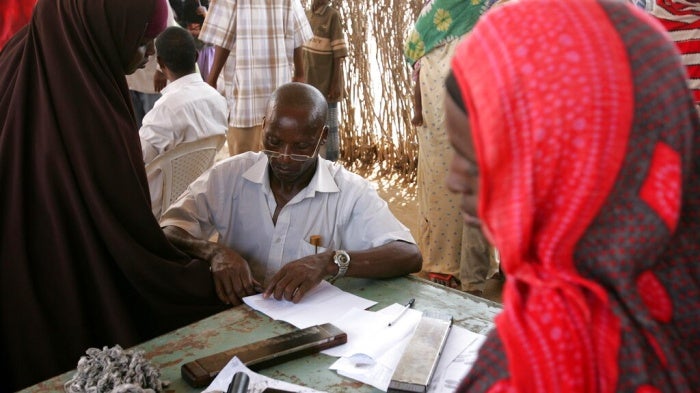 A woman has her fingerprints taken as she registers with the United Nations High Commissioner for Refugees (UNHCR) at the Liboi transit point in Kenya, near the Somali border, November 1, 2006.