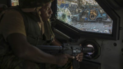 A Kenyan police officer, part of a UN-backed multinational force, patrols a street in Port-au-Prince, Haiti, December 5, 2024.