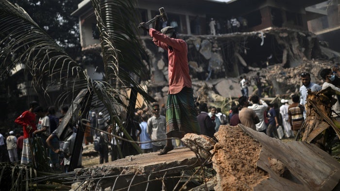 A man hammers the debris around the vandalized residence of Sheikh Mujibur Rahman, Bangladesh's former leader and the father of the country's ousted Prime Minister Sheikh Hasina, in Dhaka, Bangladesh, February 6, 2025.