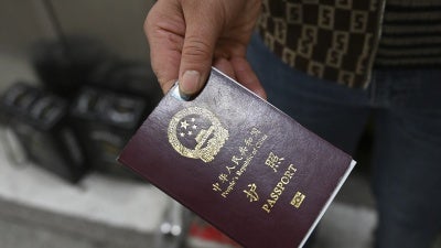 A person holds a Chinese passport