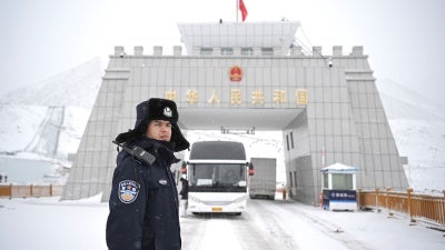 A Chinese police officer on a snowy road.