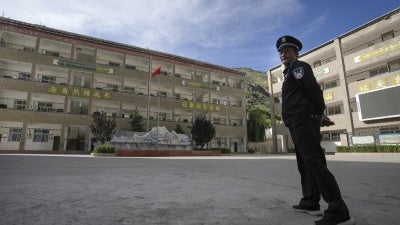 A security guard outside the Shangri-La Key School in Kardze prefecture, Sichuan province, China, September 5, 2023.