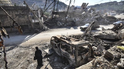 A returning resident to Nabatieh, in southern Lebanon, stands before the wreckage in the city on November 30, 2024, days after the start of a ceasefire between Israel and Hezbollah. 