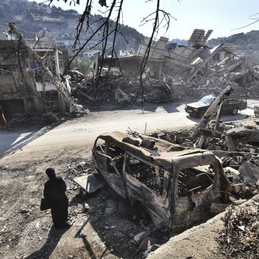 A returning resident to Nabatieh, in southern Lebanon, stands before the wreckage in the city on November 30, 2024, days after the start of a ceasefire between Israel and Hezbollah. 