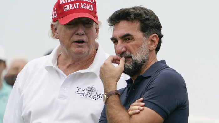 US President Donald Trump, left, talks with Yasir Al-Rumayyan, governor of Saudi Arabia's Public Investment Fund, during the Bedminster Invitational LIV Golf tournament in Bedminster, New Jersey, July 29, 2022. 