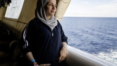 A Syrian woman, seven-month's pregnant, looks out at the Mediterranean Sea from the stern of the Geo Barents, September 20, 2024. 