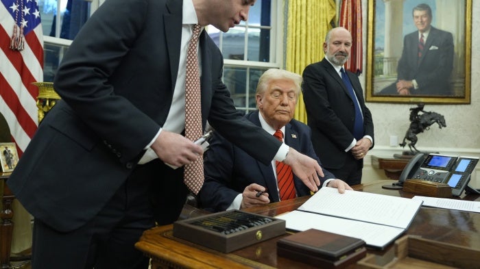 President Donald Trump signs an executive order in the Oval Office at the White House, Washington, DC, February 10, 2025.