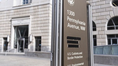 A sign with the names of US government agencies housed at the Ronald Reagan Building in Washington, DC, with the USAID headquarters taped over, February 7, 2025. 