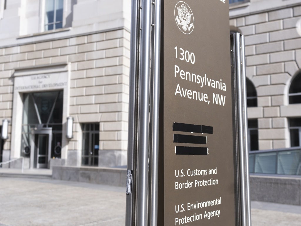 A sign with the names of US government agencies housed at the Ronald Reagan Building in Washington, DC, with the USAID headquarters taped over, February 7, 2025. 