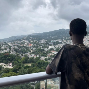 A 17-year-old Carrefour resident, associated with a criminal group, stands on a terrace, gazing out over the horizon in Port-au-Prince, Haiti, July 2024.