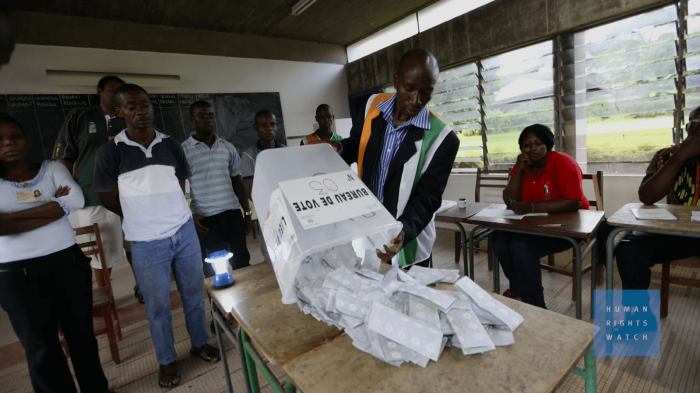 A photo of an elections center staff counting the votes.